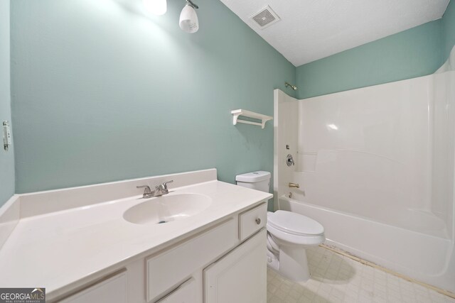 full bathroom with toilet, bathtub / shower combination, vanity, and a textured ceiling