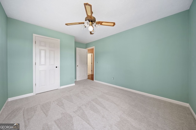 unfurnished bedroom featuring ceiling fan and light carpet