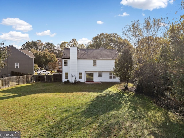 back of property with a patio and a lawn