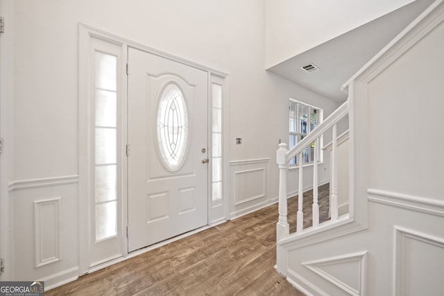 foyer entrance featuring a wealth of natural light and hardwood / wood-style flooring