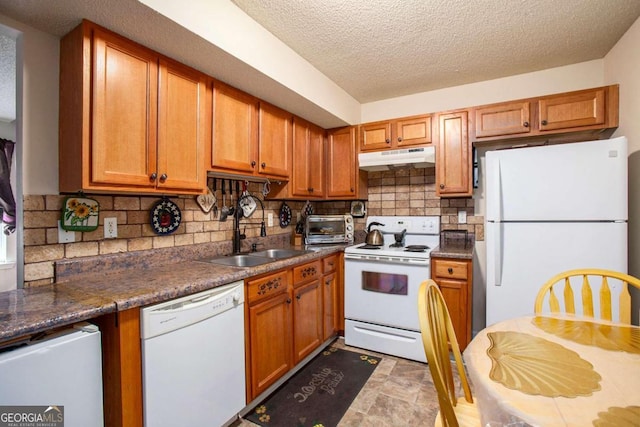 kitchen featuring white appliances, a textured ceiling, sink, and backsplash