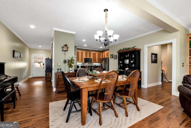 dining room with crown molding, an inviting chandelier, and dark wood-type flooring