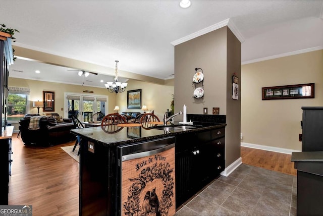 kitchen featuring dishwasher, pendant lighting, ornamental molding, dark hardwood / wood-style floors, and sink