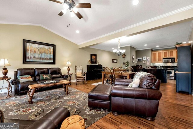 living room featuring hardwood / wood-style flooring, ceiling fan with notable chandelier, crown molding, and vaulted ceiling