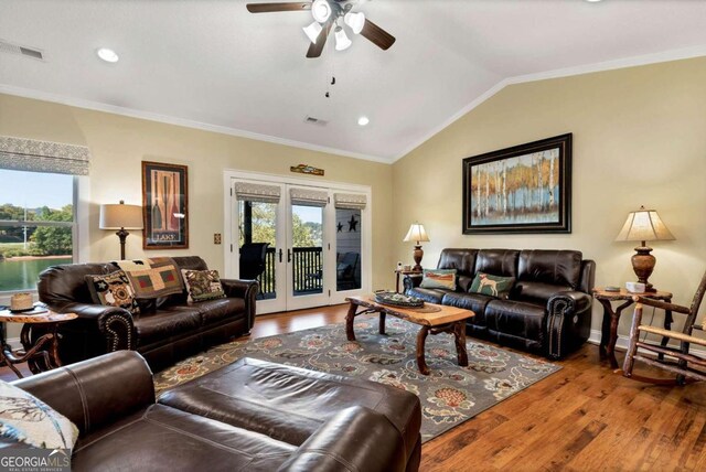 living room with ceiling fan, hardwood / wood-style flooring, lofted ceiling, and crown molding