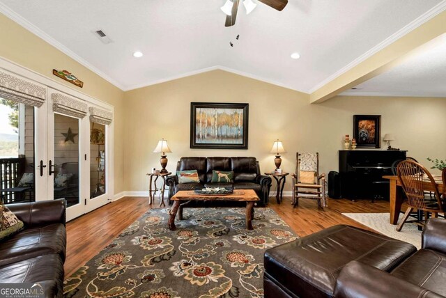 living room with crown molding, hardwood / wood-style floors, and ceiling fan