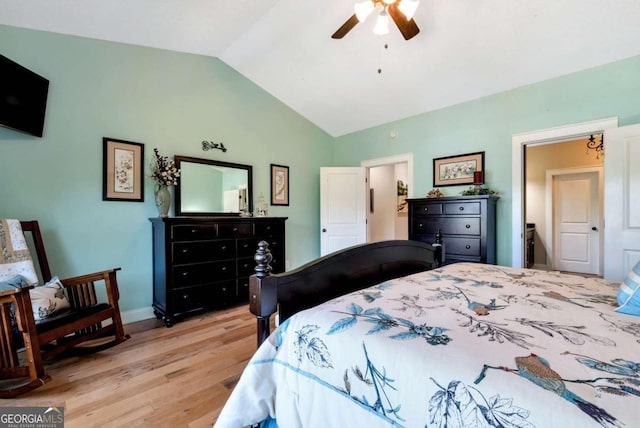 bedroom featuring ceiling fan, light wood-type flooring, and vaulted ceiling