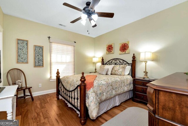 bedroom with ceiling fan and dark hardwood / wood-style flooring