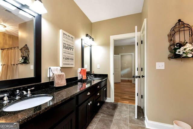 bathroom with tile patterned flooring and vanity