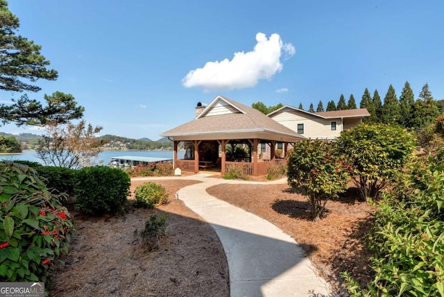 view of home's community featuring a gazebo and a water view