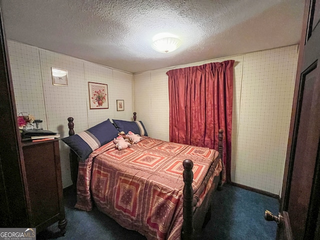 carpeted bedroom featuring a textured ceiling