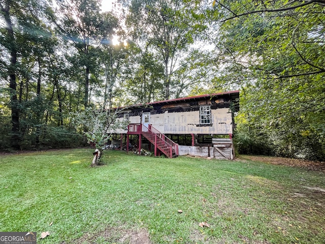 rear view of house with a lawn