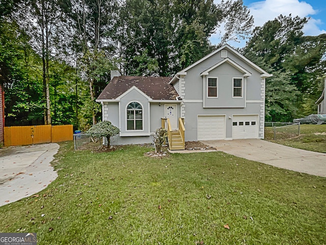 split level home featuring a garage and a front yard