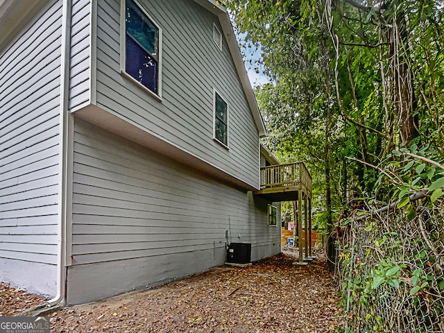 view of property exterior with a balcony and central air condition unit