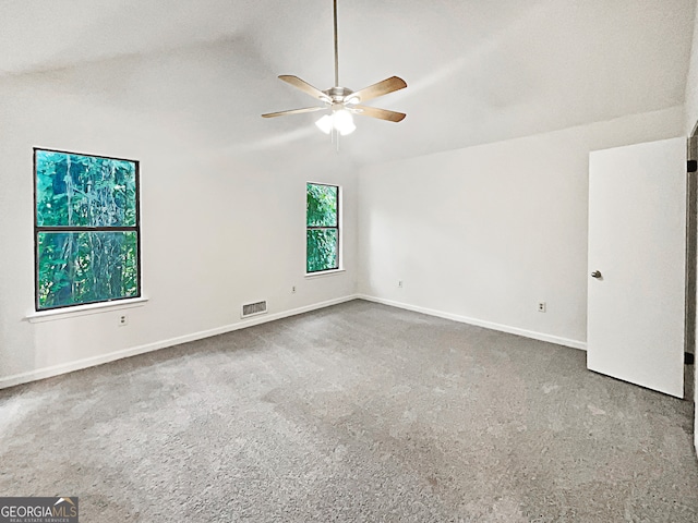 unfurnished room featuring carpet, vaulted ceiling, and ceiling fan