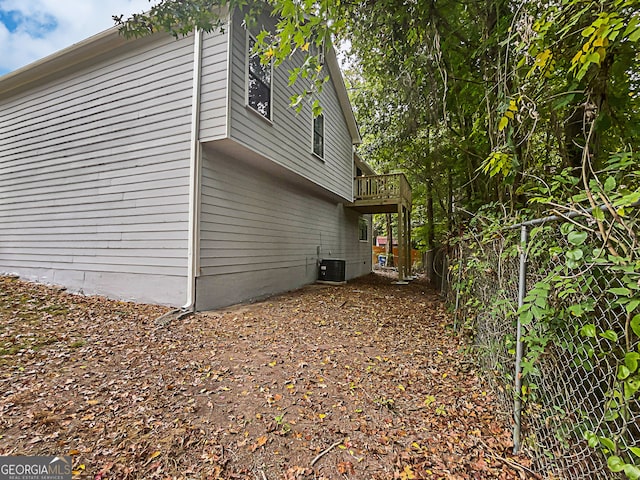 view of side of home featuring central AC