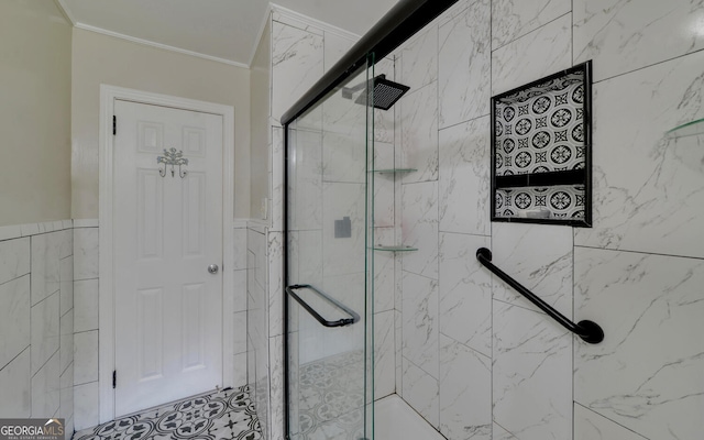 bathroom with tile walls, ornamental molding, and a shower with shower door