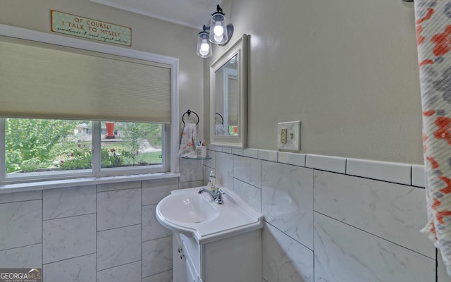 bathroom featuring vanity and tile walls