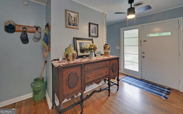 entryway with a wealth of natural light, ceiling fan, hardwood / wood-style flooring, and crown molding