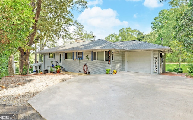 ranch-style home with a garage and central AC