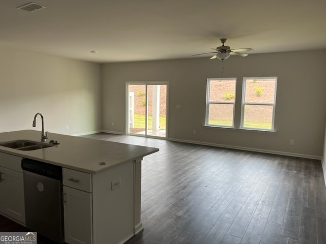 kitchen with white cabinetry, an island with sink, dishwasher, dark hardwood / wood-style floors, and sink