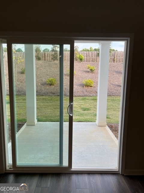 doorway to outside with a healthy amount of sunlight and dark hardwood / wood-style floors