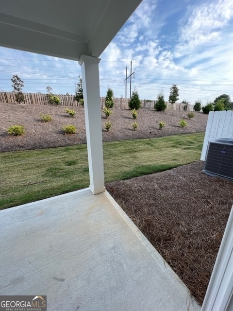 view of yard featuring cooling unit and a patio