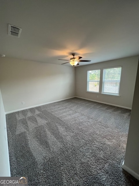 carpeted empty room featuring ceiling fan