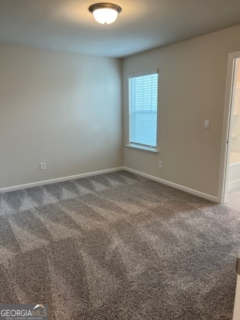 spare room featuring carpet flooring