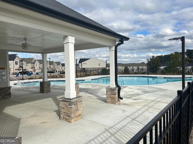 view of swimming pool featuring a patio and ceiling fan