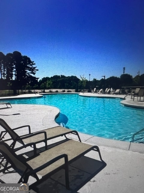 view of swimming pool with a patio