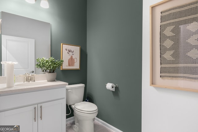 bathroom featuring tile patterned flooring, vanity, and toilet