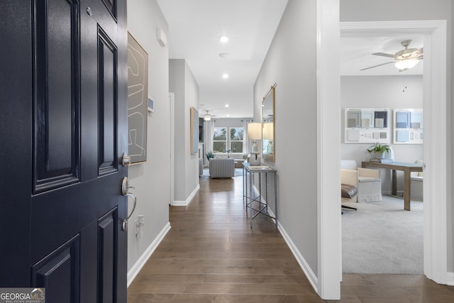 hallway with dark hardwood / wood-style flooring