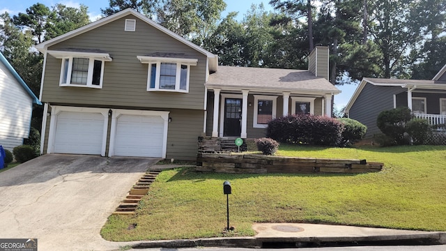 tri-level home featuring a front yard and a garage