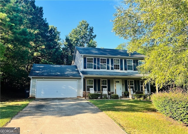 view of front of house featuring a garage, covered porch, and a front yard