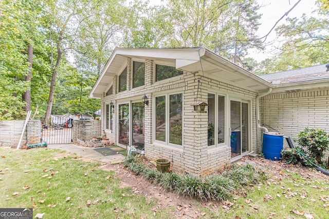 view of side of home featuring a lawn