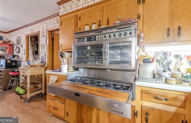 kitchen with crown molding and light wood-type flooring