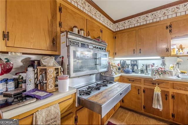 kitchen featuring crown molding and light wood-type flooring