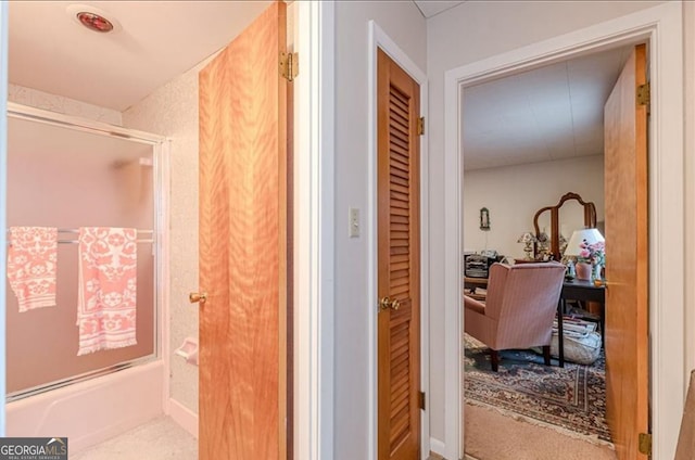 bathroom featuring shower / bath combination with glass door