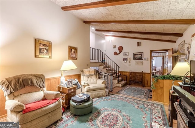 living room featuring lofted ceiling with beams, wood-type flooring, and wooden walls