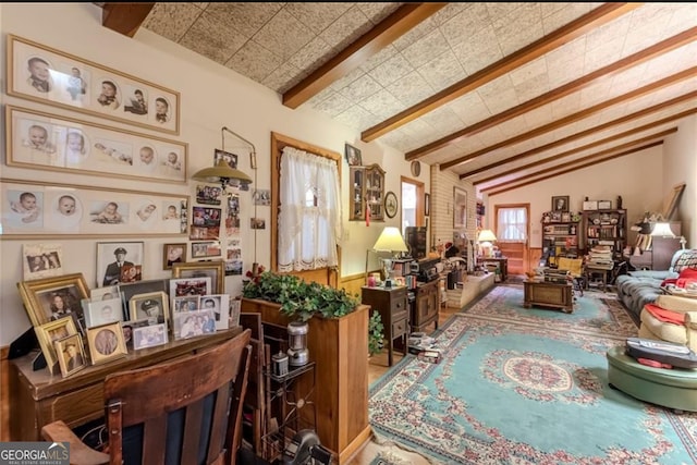 interior space featuring vaulted ceiling with beams