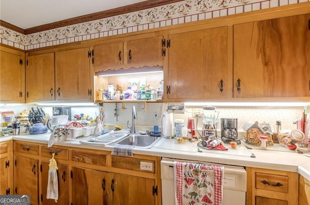 kitchen with white dishwasher, sink, and crown molding