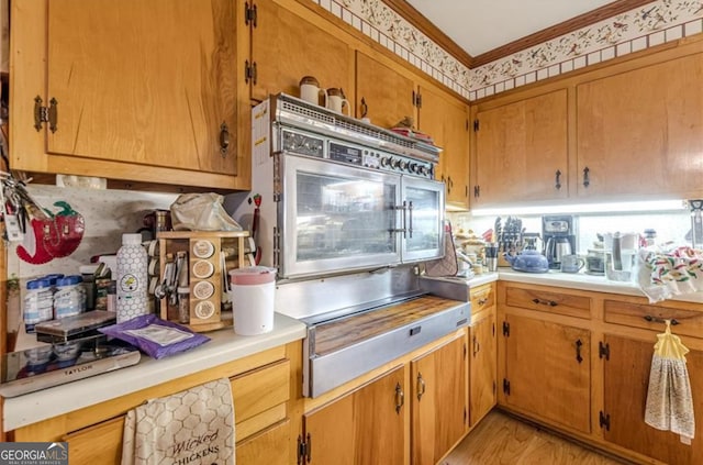 kitchen featuring light hardwood / wood-style flooring and ornamental molding