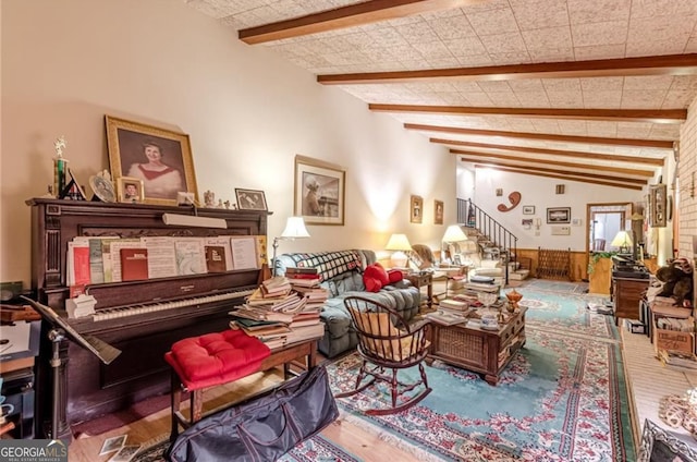 interior space featuring lofted ceiling with beams and hardwood / wood-style flooring