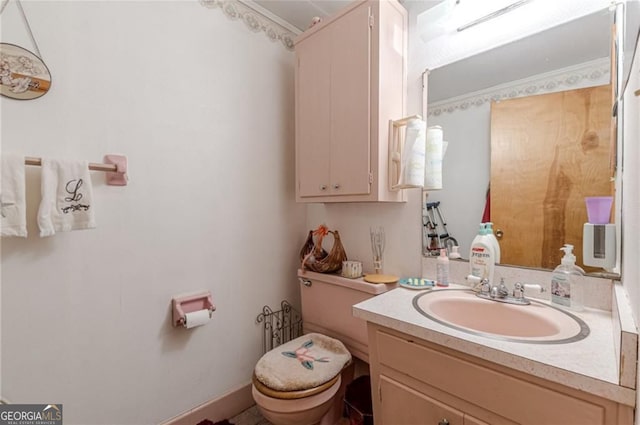 bathroom featuring vanity and toilet