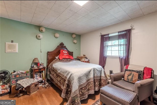 bedroom with hardwood / wood-style flooring