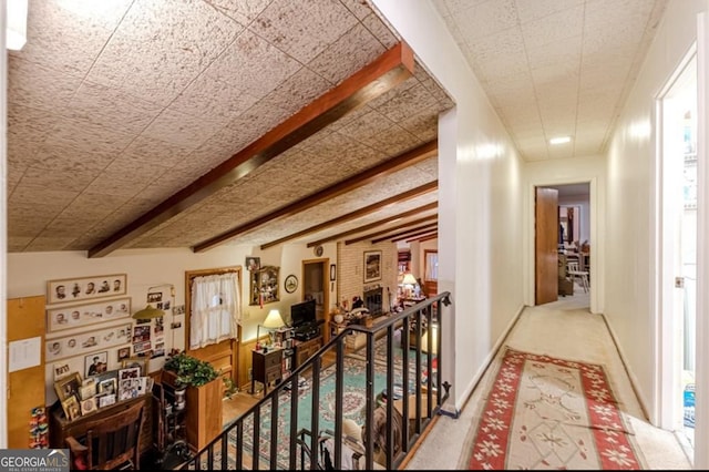 hall featuring lofted ceiling with beams and carpet floors