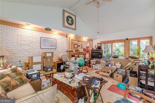 living room featuring beamed ceiling, brick wall, hardwood / wood-style floors, high vaulted ceiling, and ceiling fan