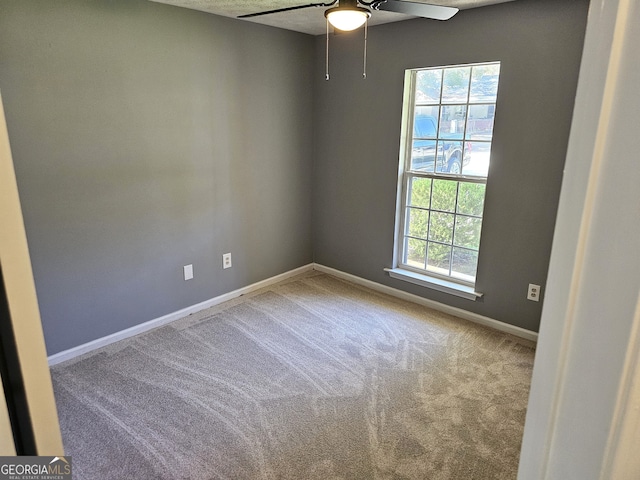 spare room with carpet, plenty of natural light, and ceiling fan