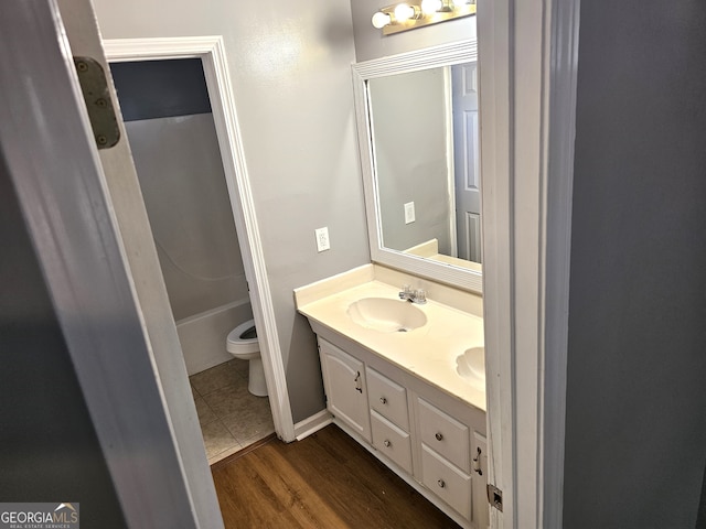 bathroom featuring vanity, hardwood / wood-style floors, and toilet